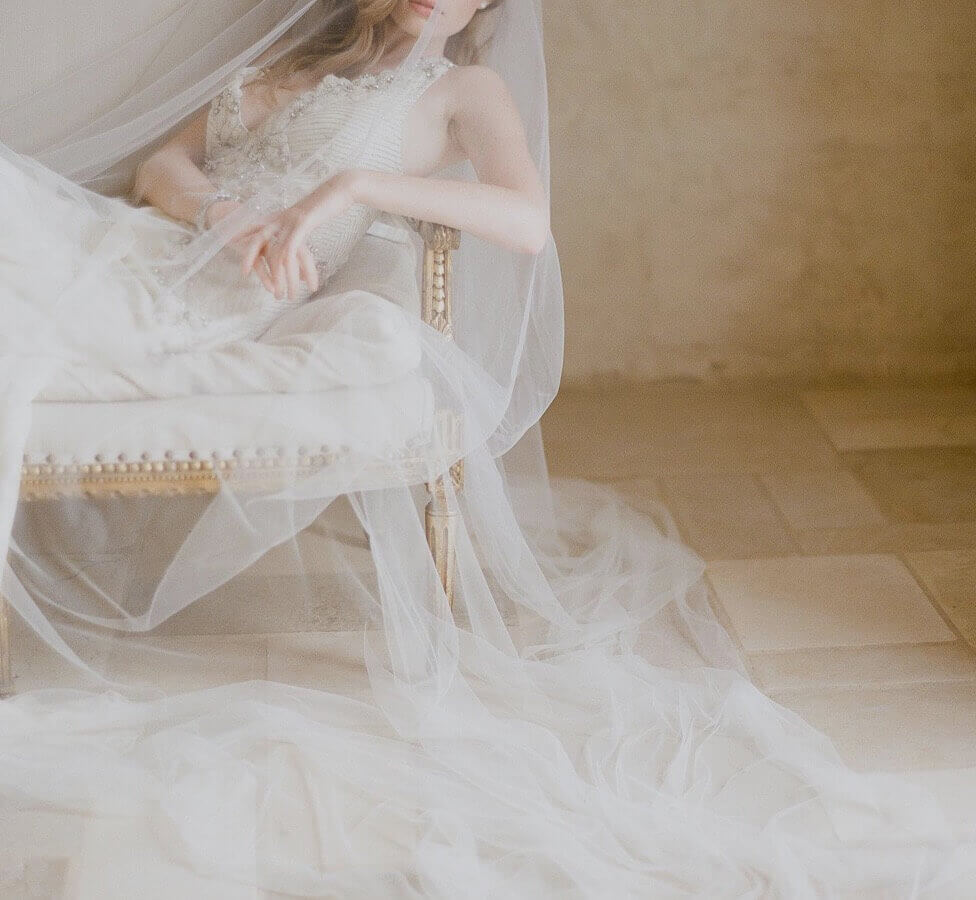 Model wearing a long Bella Bridal veil